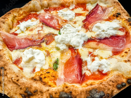 Tasty pizza with cheese and raw ham