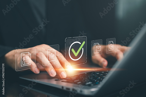 Hand typing on laptop with glowing checkmark and document icons, representing digital approval, data validation, workflow automation and efficient business process management in modern online systems.
