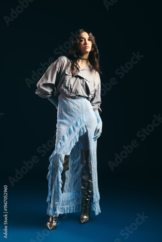 Konstfotografi Stylish young woman showcases elegant ensemble in a modern studio setting