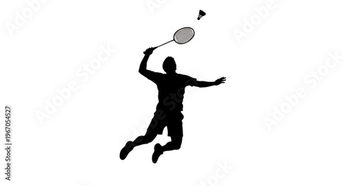 Silhouette of a Badminton Player in Mid-Air During a Smash.