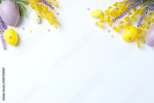 Easter composition with festive eggs, spring mimosa and lavender flowers on white background, top view, space for text