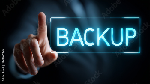 Hand pressing glowing backup button in dark environment, representing data security and technology. Concept of digital protection and information management in modern business.