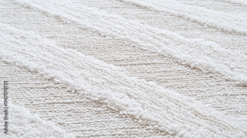 A close-up view of a fluffy, off-white rug with diagonal stripes.