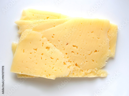 Top View of Sliced Semi-Hard Cheese on White Background, Textured Swiss Style Cheese Slices for Culinary Use, Healthy Dairy Snack and Ingredient Detail
