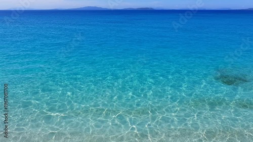 Crystal Clear Turquoise Ocean Water with Gentle Waves and Distant Horizon.