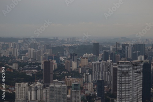 Kuala Lumpur,Malaysia 23rd June 2023 Wide panoramic shot of the Kuala Lumpur city skyline on a hazy afternoon, showcasing rows of towering commercial skyscrapers stretching to the horizon.