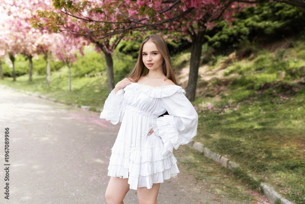 custom made wallpaper toronto digitalYoung beautiful woman in white romantic dress standing under blooming cherry blossom trees in spring garden. spring mood. Perfect for themes of spring, beauty, romance, nature and lifestyle.