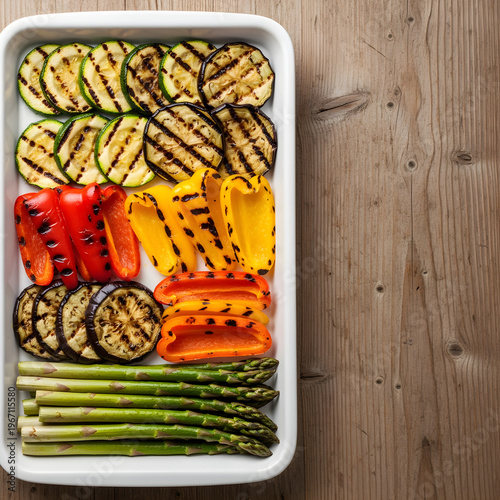 Healthy meal prep vegetables for diet planning with grilled zucchini peppers and eggplant organized container top view