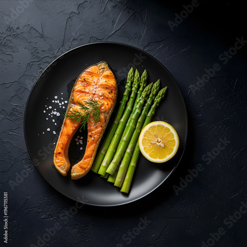 High protein salmon meal for fitness diet concept with grilled fish asparagus and lemon gourmet healthy plating