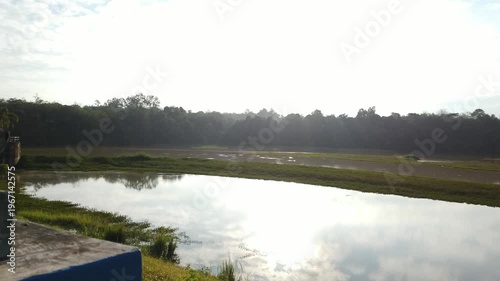 Murky water in a dam area showing sediment and low clarity. The scene highlights environmental conditions and water quality in a reservoir setting.