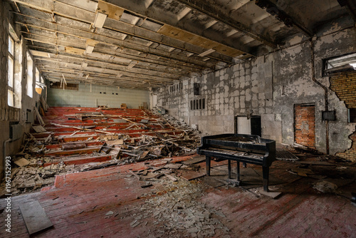View of an abandoned auditorium with a grand piano and debris on the floor in Pripyat, Kyiv Oblast, Ukraine.