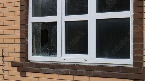 a broken window corner in an uninhabited new house with dusty glass and a dark, empty interior, as a symbol of a crime, theft, violence, or the destruction of an uninhabited cottage