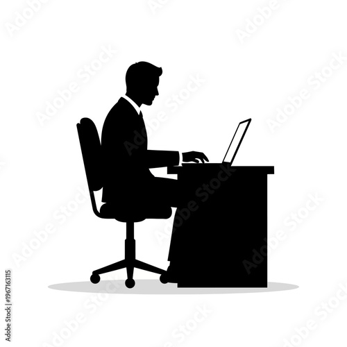 Silhouette of businessman working on laptop at desk in office, side view