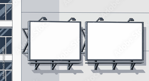Two blank billboards mounted on a building facade with attached lights