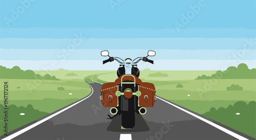 Motorcycle with saddlebags on a winding road through green fields
