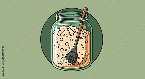 A glass jar filled with a bubbly, light-colored substance and a wooden spoon
