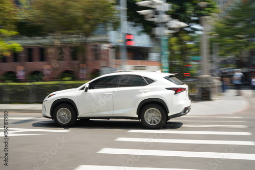 Photography White Luxury SUV Driving on Urban City Street