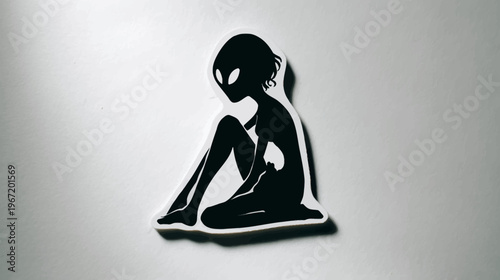 Silhouette of an alien figure sitting with a thoughtful expression