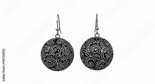 Pair of dangling round earrings with ornate swirling silver patterns on black