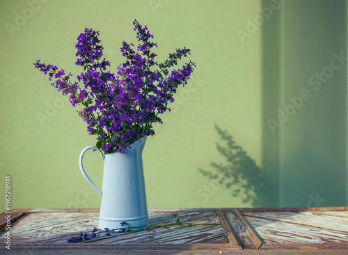 Purple Flowers in a White Vase