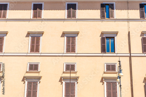 Wall house facade. Old building architecture in city Italy, Rome. Italian windows with shutters.
