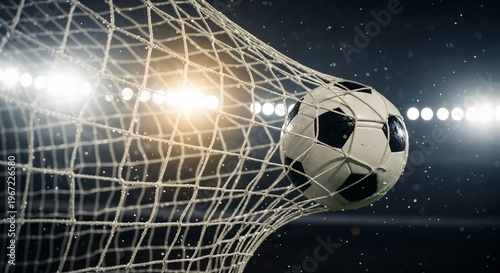 Soccer ball hits the net in a stadium during a night match while fans cheer