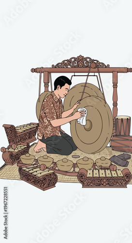 A man in patterned attire polishes a large metallic gong within a gamelan set