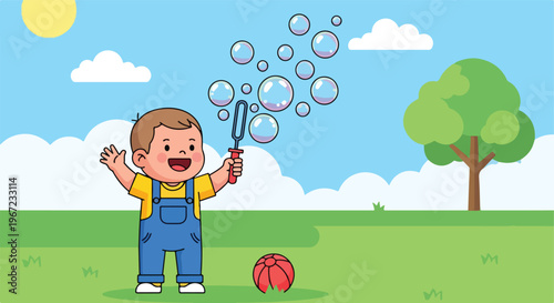 A happy young boy wearing overalls plays with soap bubbles in a grassy park