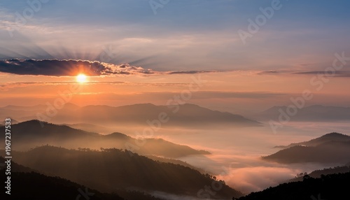 Majestic Sunrise Over Misty Mountains with Colorful Cloud Display