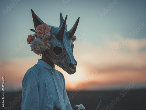 Ethereal Animal Mask Skull with Horns at Dusk: Surreal Ritual Photography with Flowers and Sunset Silhouette in Nature Landscape - An Artistic and Mysterious Tribal Costume Fantasy Portrait