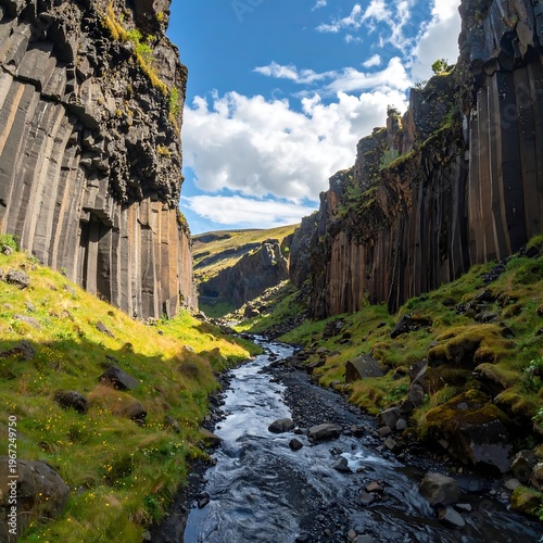 A serene river flows through a rugged canyon with towering basalt columns