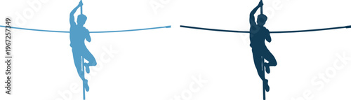 Silhouette of two people ziplining on a cable in the air