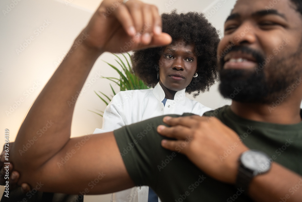 Obraz premium Physical therapists are checking patients shoulder at the clinic office room.