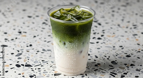 Refreshing Iced Matcha Latte - A Cool and Creamy Beverage in a Clear Plastic Cup.