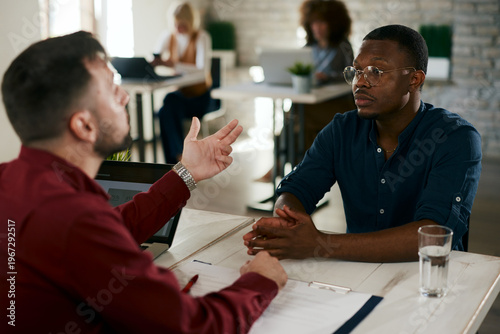 Cuadro en lienzo Businessman interviewing applicant during a recruitment meeting in an open space