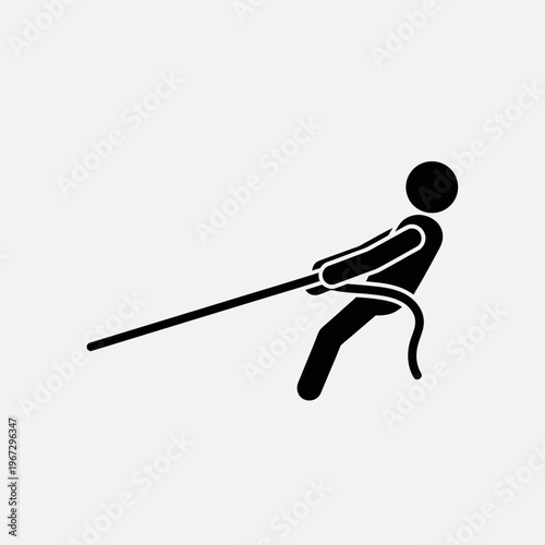 Man pulling rope with determination and strength in a tug of war competition.