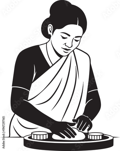 Woman in sari making food on a traditional indian kitchen tool
