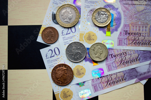 British pounds close-up on a chessboard background. National currency of Great Britain