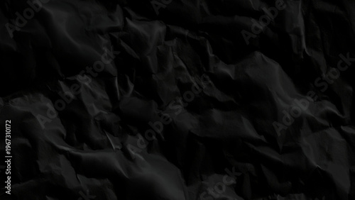 Crumpled black paper texture background with wrinkles and folds abstract dark material