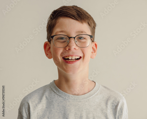 Smiling boy with glasses portrait isolated on white background