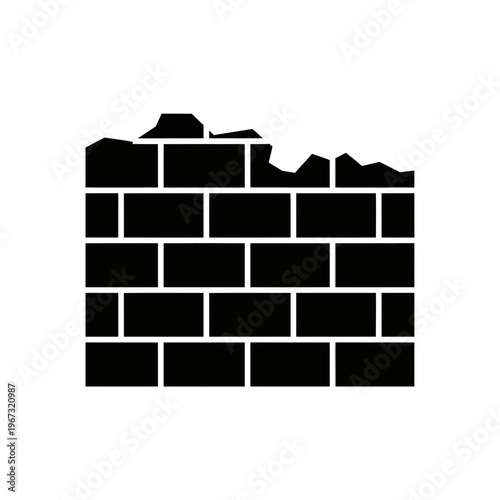 Damaged brick wall with missing bricks showing structural weakness and decay.