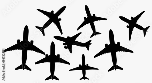 Silhouettes of multiple airplanes in various orientations on a white background.