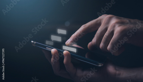 Hand Holding Smartphone with Glowing Screen and Floating Chat Bubbles in Dark