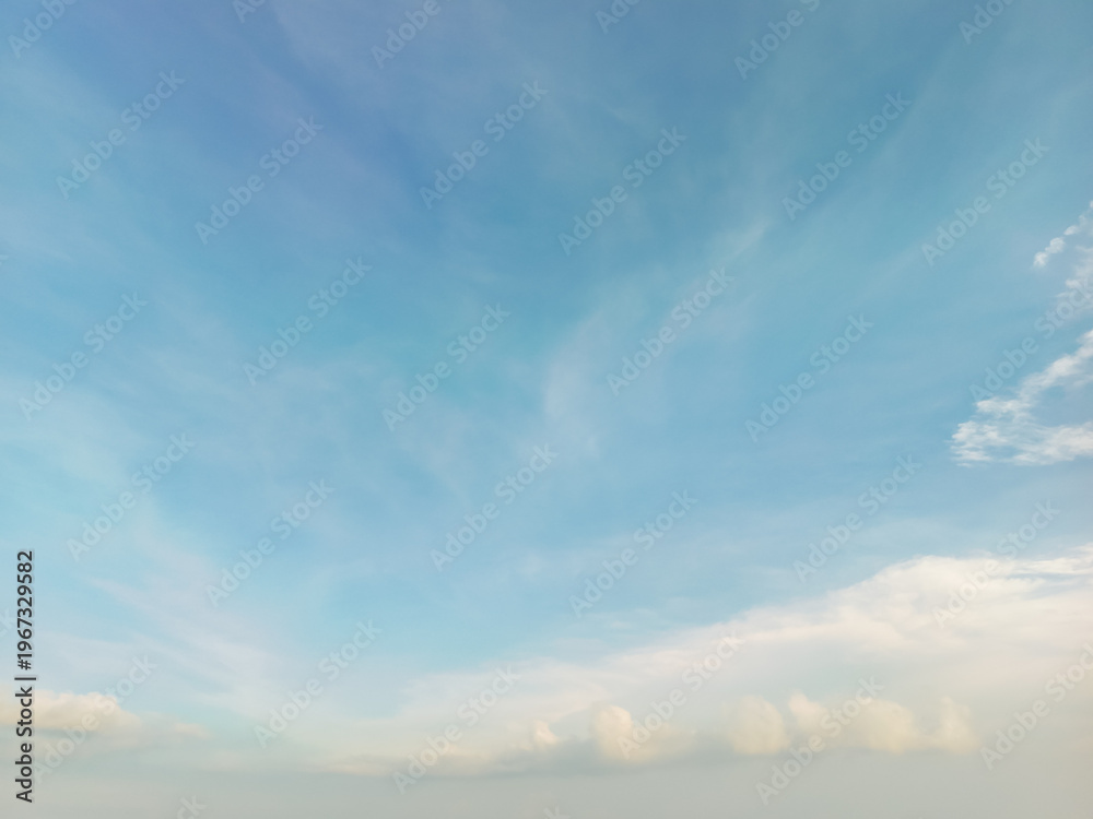 Fototapeta premium Expansive Blue Sky with Soft White Clouds and Gentle Atmospheric Background for Nature Concepts