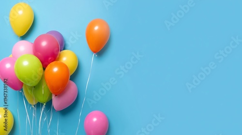 Colorful Balloons Float Against a Bright Blue Background During a Celebration...