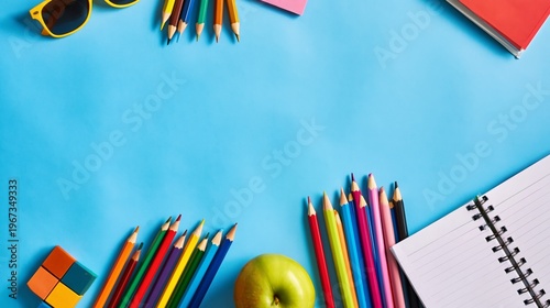 Colorful School Supplies Arranged on a Bright Blue Background for Creative Pr...