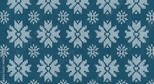 Cozy winter pattern featuring white knitted snowflakes and geometric shapes on a textured dark blue fabric background for a warm feel.