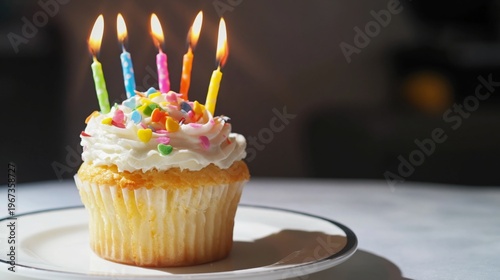 Cupcake With Candles on a Plate During a Celebration in a Bright Room