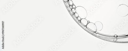 Oil droplets abstract patterns in transparent petri dish, banner format