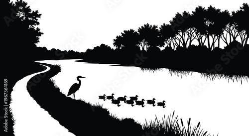 Peaceful waterside scene with birds and trees in dark silhouette